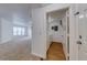 View of hallway leading to in-unit laundry room with wood-look flooring at 5500 Metrowest Blvd # 203, Orlando, FL 32811