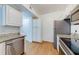 Well-lit kitchen features stainless steel appliances, granite countertops, and wooden flooring at 5500 Metrowest Blvd # 203, Orlando, FL 32811