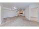 Open-plan living room features neutral carpet, light walls, and an open view into the kitchen at 5500 Metrowest Blvd # 203, Orlando, FL 32811