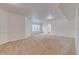 Spacious living room with neutral carpet, light walls, and bright windows at 5500 Metrowest Blvd # 203, Orlando, FL 32811