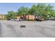 Exterior shot of a parking lot in front of the condo buildings with mature trees around at 5500 Metrowest Blvd # 203, Orlando, FL 32811