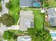 Aerial view shows home's backyard with pool, landscaping and privacy fence at 609 Langholm Dr, Winter Park, FL 32789