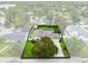 Aerial view shows the property's backyard with a well manicured lawn and mature shade trees at 609 Langholm Dr, Winter Park, FL 32789