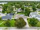 Aerial view of a home with a pool, green lawn, and mature trees at 609 Langholm Dr, Winter Park, FL 32789