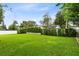 Green backyard with privacy hedges and a storage shed at 609 Langholm Dr, Winter Park, FL 32789