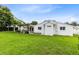 Lush backyard with a well-maintained lawn, providing ample green space at 609 Langholm Dr, Winter Park, FL 32789