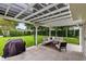 Spacious backyard featuring a patio, grill, and lush green lawn at 609 Langholm Dr, Winter Park, FL 32789