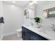Bright bathroom featuring double vanity with modern fixtures, white countertops, and clean lines at 609 Langholm Dr, Winter Park, FL 32789