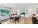 Bright dining area with views to the living room and a large window overlooking the lush front yard at 609 Langholm Dr, Winter Park, FL 32789