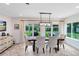 Bright dining room featuring a wooden table, upholstered chairs, and backyard views through sliding glass doors at 609 Langholm Dr, Winter Park, FL 32789