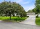 Well-maintained home featuring a spacious driveway, mature landscaping, and an attached two-car garage at 609 Langholm Dr, Winter Park, FL 32789