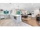 Open concept kitchen with a large island, stainless steel appliances, and views to the dining and living areas at 609 Langholm Dr, Winter Park, FL 32789