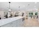 Spacious kitchen island with marble countertop, stainless steel microwave, and adjacent views of the dining area at 609 Langholm Dr, Winter Park, FL 32789