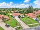 An aerial view showcasing the property with a long driveway and beautiful landscaping at 6321 Clearmeadow Ct, Windermere, FL 34786
