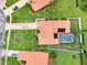 A bird's-eye view of a home with a pool, landscaping, and distinctive tile roof at 6321 Clearmeadow Ct, Windermere, FL 34786