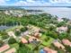 Expansive aerial view of a beautiful home with a private pool surrounded by lush landscaping near a lake at 6321 Clearmeadow Ct, Windermere, FL 34786