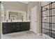 Modern bathroom features dual sinks, a large mirror, and a sleek glass-enclosed shower at 6321 Clearmeadow Ct, Windermere, FL 34786