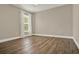 Bright and spacious bedroom boasts wood floors, base trim, and a window to bring in light at 6321 Clearmeadow Ct, Windermere, FL 34786