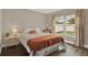 Cozy bedroom with hardwood floors, a large window, and warm lighting for a comfortable feel at 6321 Clearmeadow Ct, Windermere, FL 34786