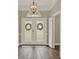 Welcoming foyer with double doors, decorative lighting, and hardwood flooring. Ready to be customized at 6321 Clearmeadow Ct, Windermere, FL 34786