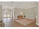 Spacious living room showcasing hardwood floors, neutral walls, and an abundance of natural light at 6321 Clearmeadow Ct, Windermere, FL 34786