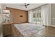 Bright living room featuring modern paneling, hardwood floors, and sliding glass doors to the pool at 6321 Clearmeadow Ct, Windermere, FL 34786
