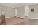 Open living room featuring hardwood floors, neutral walls, and access to other rooms at 6321 Clearmeadow Ct, Windermere, FL 34786