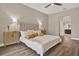 Comfortable main bedroom with neutral tones, wood floors, ceiling fan, and ensuite bathroom at 6321 Clearmeadow Ct, Windermere, FL 34786