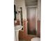 Bathroom featuring a pedestal sink, glass enclosed shower, and unique tile design at 637 15Th St, Debary, FL 32713