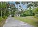 View of the home's exterior with a long driveway and mature landscaping at 637 15Th St, Debary, FL 32713
