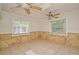 Bright living room with neutral tile flooring, natural lighting, and two ceiling fans at 637 15Th St, Debary, FL 32713