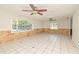 Spacious living room with tile flooring, ceiling fans, and natural light from large windows at 637 15Th St, Debary, FL 32713