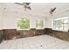 Well-lit living room features tile floors, ceiling fans, and windows for natural light at 637 15Th St, Debary, FL 32713