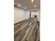 Finished basement with gray wood-look vinyl floors and recessed lighting at 6849 Palomino Dr, Lakeland, FL 33811