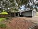 Home with a stone facade, mature landscaping, and ample parking at 6849 Palomino Dr, Lakeland, FL 33811
