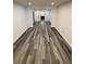 Hallway with new gray and brown wood flooring at 6849 Palomino Dr, Lakeland, FL 33811