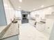 Bright kitchen featuring white cabinets, granite countertops, stainless steel appliances, and new flooring at 6849 Palomino Dr, Lakeland, FL 33811