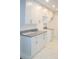 Bright kitchen featuring white cabinets, granite countertops, stainless steel appliances, and new flooring at 6849 Palomino Dr, Lakeland, FL 33811