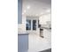 Bright kitchen featuring white cabinets, granite countertops, stainless steel appliances, and new flooring at 6849 Palomino Dr, Lakeland, FL 33811