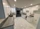 Renovated kitchen with white cabinetry, granite countertops, and modern fixtures at 6849 Palomino Dr, Lakeland, FL 33811