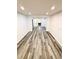 Spacious living room featuring modern flooring, recessed lighting, and freshly painted white walls at 6849 Palomino Dr, Lakeland, FL 33811
