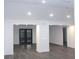 Spacious living room featuring modern flooring, recessed lighting, and freshly painted white walls at 6849 Palomino Dr, Lakeland, FL 33811