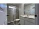 Bathroom featuring a vanity with sink, toilet, and shower with glass doors at 720 Las Fuentes Dr, Kissimmee, FL 34746