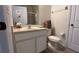 Bathroom showcasing a vanity with sink, toilet, and shower with glass doors at 720 Las Fuentes Dr, Kissimmee, FL 34746