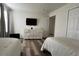 Bright and airy bedroom with two beds, closet, wood-look floors and a wall-mounted TV at 720 Las Fuentes Dr, Kissimmee, FL 34746