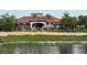 Exterior view of the community center with a large pond and decorative landscaping at 720 Las Fuentes Dr, Kissimmee, FL 34746