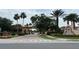 Community entrance with decorative fountain and landscaped median at 720 Las Fuentes Dr, Kissimmee, FL 34746