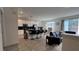 Open concept living room with kitchen island, stainless appliances, tile floors, and modern furniture at 720 Las Fuentes Dr, Kissimmee, FL 34746