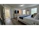 Comfortable main bedroom with ensuite bath, neutral colors, wood-look floors and lots of natural light at 720 Las Fuentes Dr, Kissimmee, FL 34746