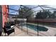 Screened-in pool area featuring a safety fence, providing a secure and enjoyable outdoor space at 720 Las Fuentes Dr, Kissimmee, FL 34746